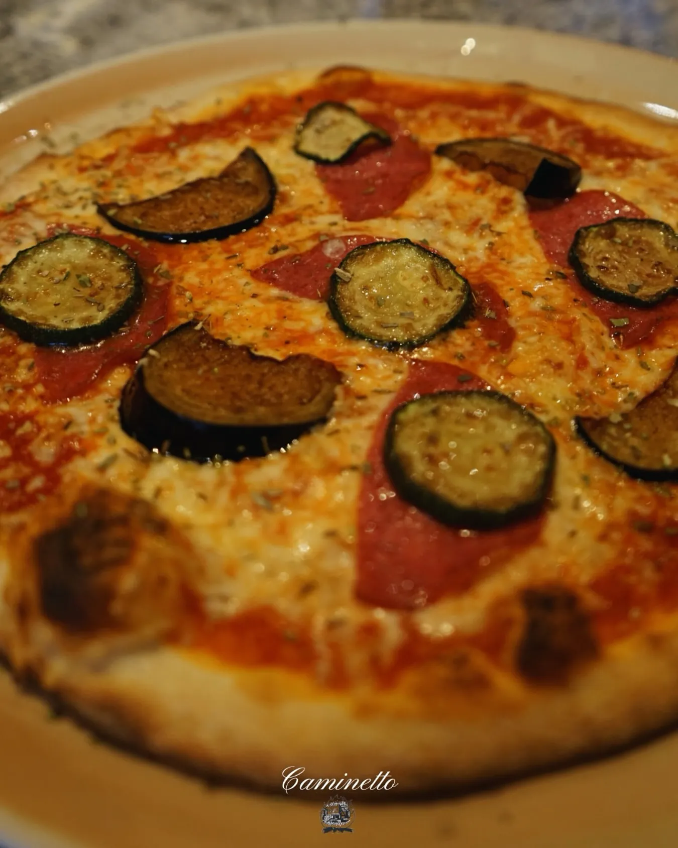 Frisch gebackene Pizza aus dem Holzofen in Nahaufnahme.